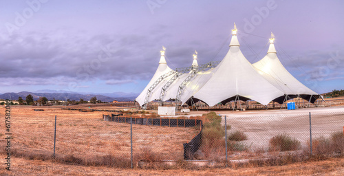 Sunset over a large circus tent in a Southern California field in summer.