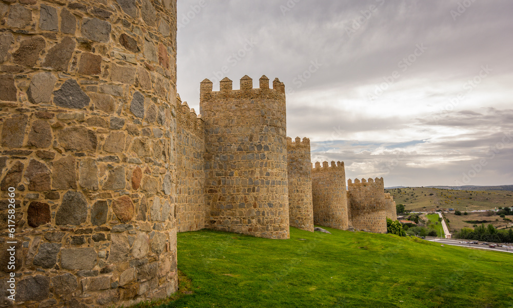 Walls of the historic city of Avila,at the blue hour, in Spain. the old city of Avila and its extramural churches were declared a World Heritage site by UNESCO