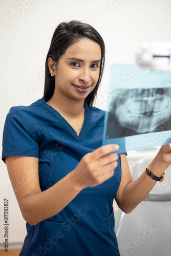 dentist reviewing x-ray examination of patient's mouth, medical diagnosis and treatment, medicine and healthcare, young woman with professional occupation