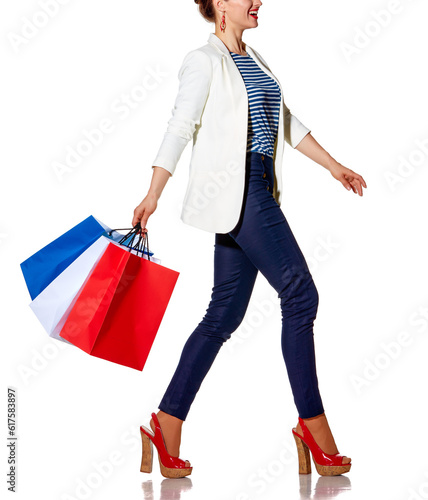 Shopping. The French way. Full length portrait of happy young woman with French flag colours shopping bags going to the side on white background