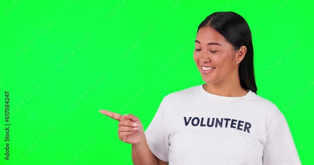 Green screen, volunteer and a woman pointing at space for advertising, charity or information. Happy asian person with list and tshirt for nonprofit presentation, NGO checklist or donation in studio Green screen, volunteer and a woman pointing at space for advertising, charity or information. Happy asian person with list and tshirt for nonprofit presentation, NGO checklist or donation in studio