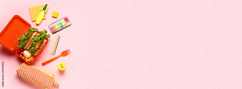 Lunch box of tasty food and school stationery on pink background with space for text