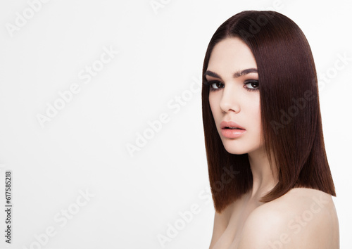 Beauty portrait model with shiny brown hairstyle with pink lips on white background