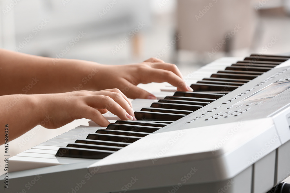 Fototapeta premium Woman playing modern synthesizer, closeup