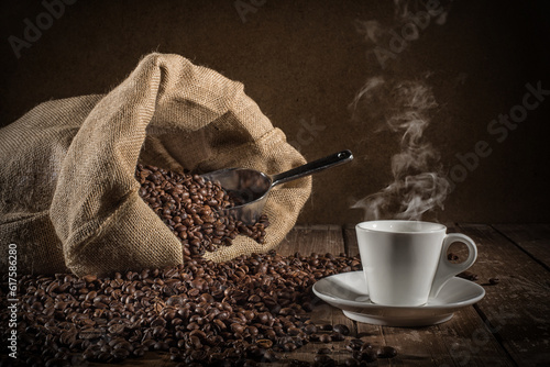 Background of cup of coffee beans with jute bag and bailer photo