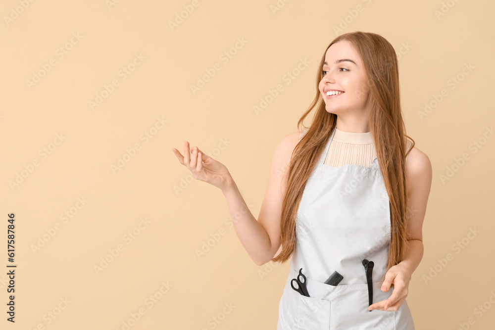 Female hairdresser showing something on beige background Female hairdresser showing something on beige background