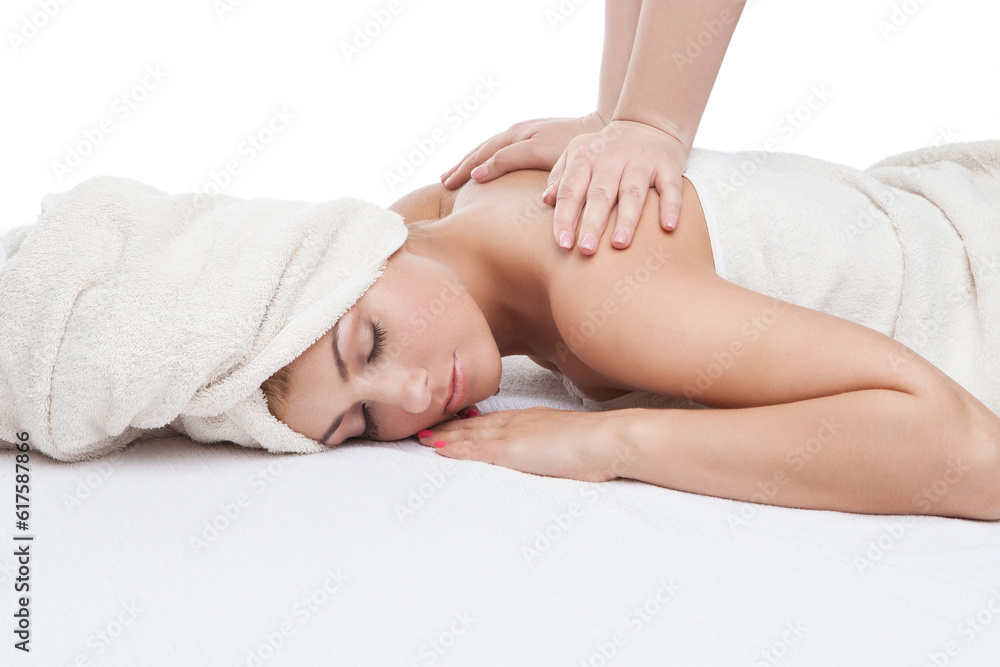 Beautiful young woman in towel getting back massage. Isolated on white background. Copy space. Beautiful young woman in towel getting back massage. Isolated on white background. Copy space.