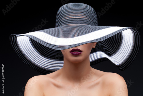 Beautiful young woman in big summer hat