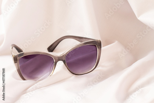 stylish women s sunglasses on a white cloth background