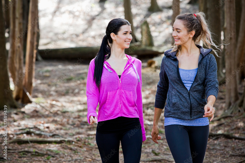 young fit caucasian women exercising outdoors. Hiking. Natural settings in the woods.