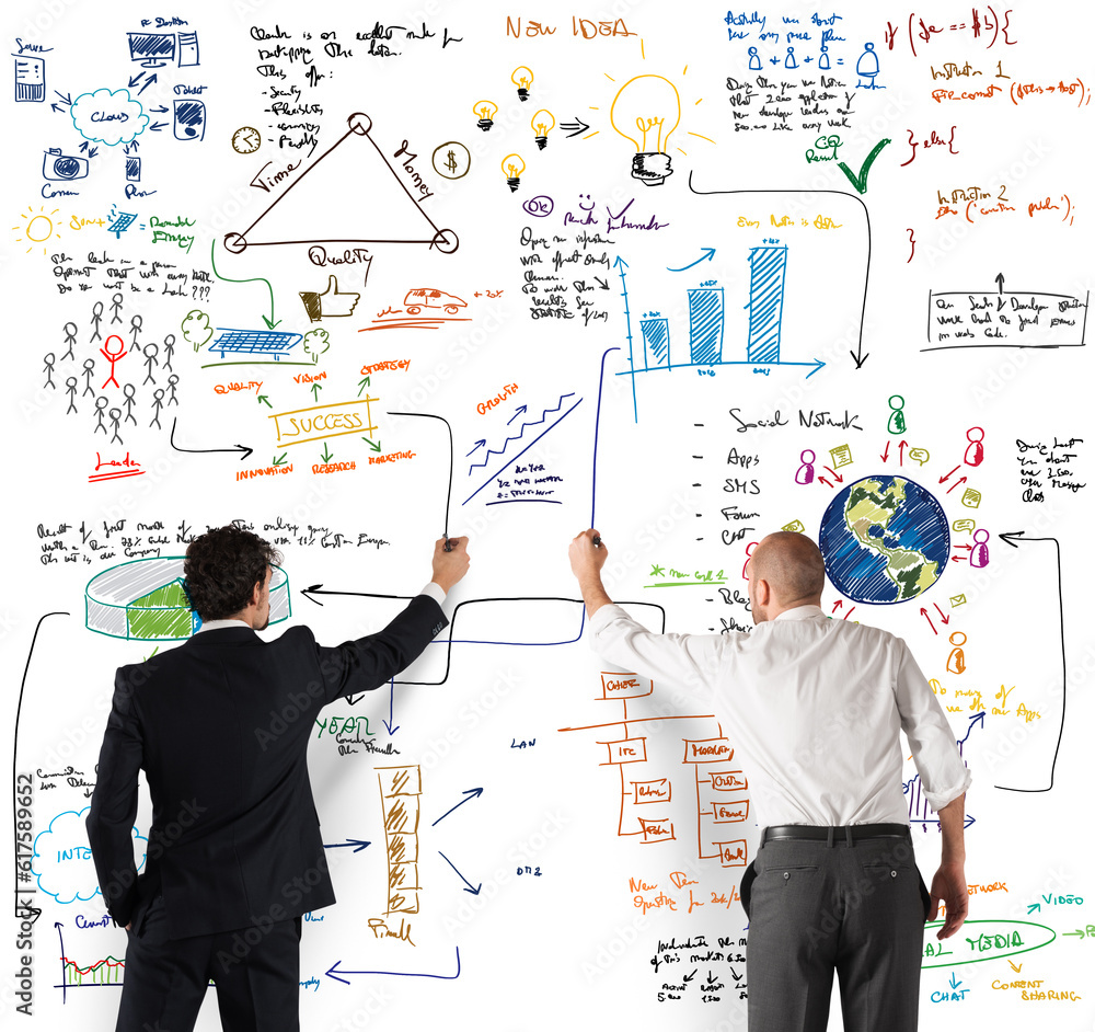 Business team drawing a new complex project on wall Business team drawing a new complex project on wall