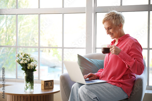 Mature woman with cup of co...