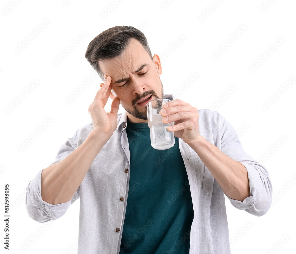 Young man drinking water with dissolved tablet on white background Young man drinking water with dissolved tablet on white background