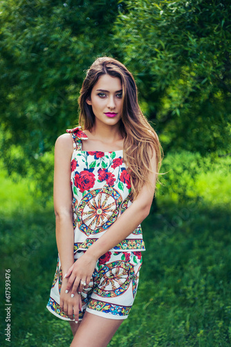 Portrait of young beautiful woman wearing trendy summer outfit posing in park. Professional make-up and hairstyle. Perfect skin. Fashion photo. Natural beauty. Springtime. © Designpics