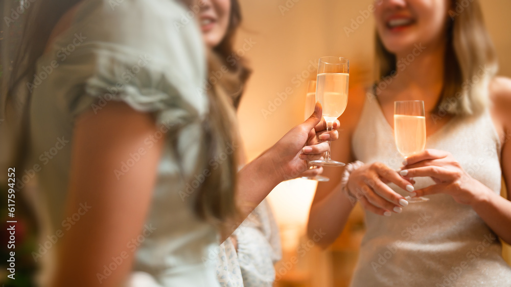 Group of friends celebrating with champagne  Close up on hands.