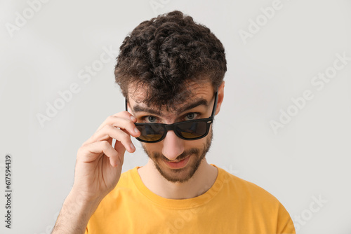 Young brunette man in sungl...