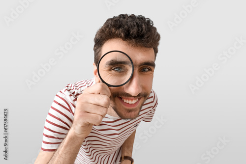 Young man looking through m...