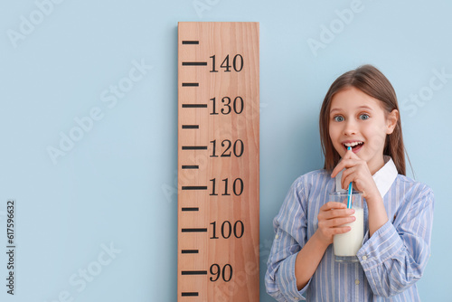 Little girl with glass of m...