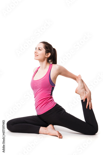 Young woman practices aerial anti-gravity yoga with a hammock in a white studio