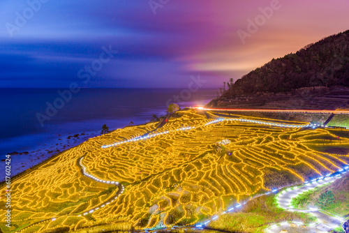 Wajima, Japan at Shiroyone Senmaida rice terraces at night. photo