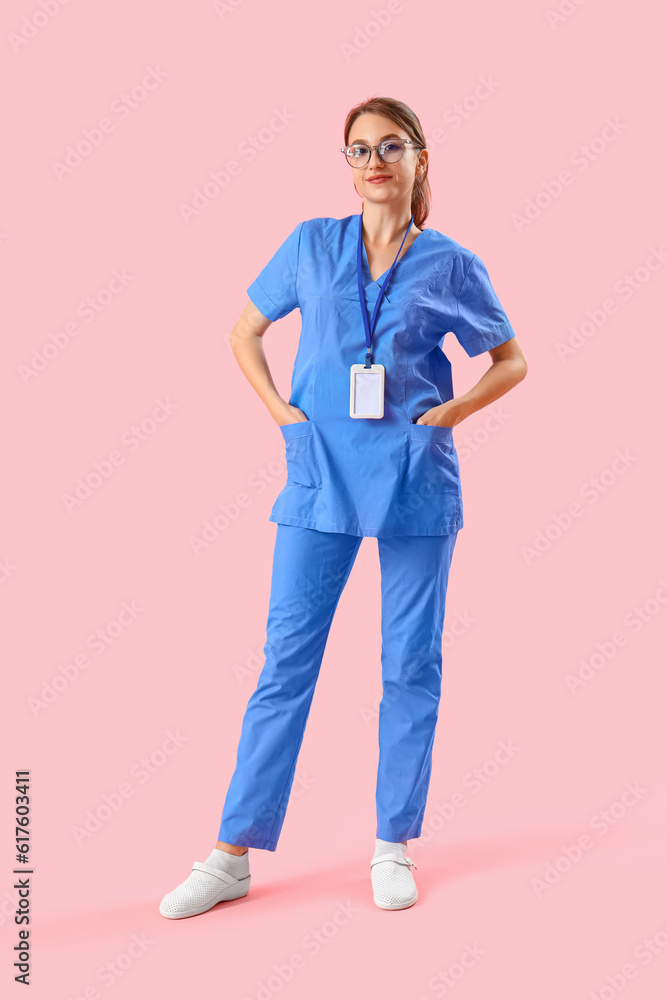 Female medical intern on pink background Female medical intern on pink background