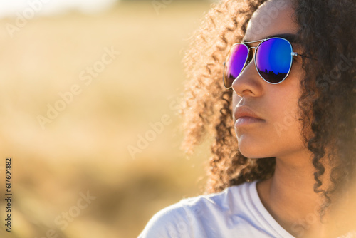 Fotografija A beautiful and thoughtful mixed race African American female girl child teenage