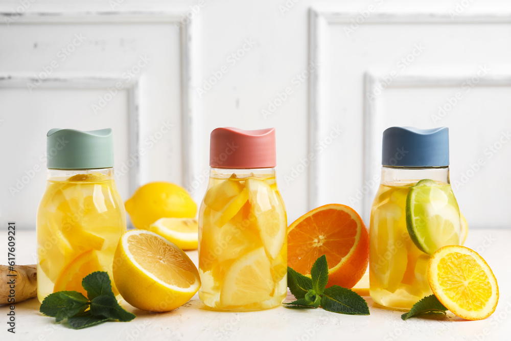 Bottles of infused water with lemon on table Bottles of infused water with lemon on table