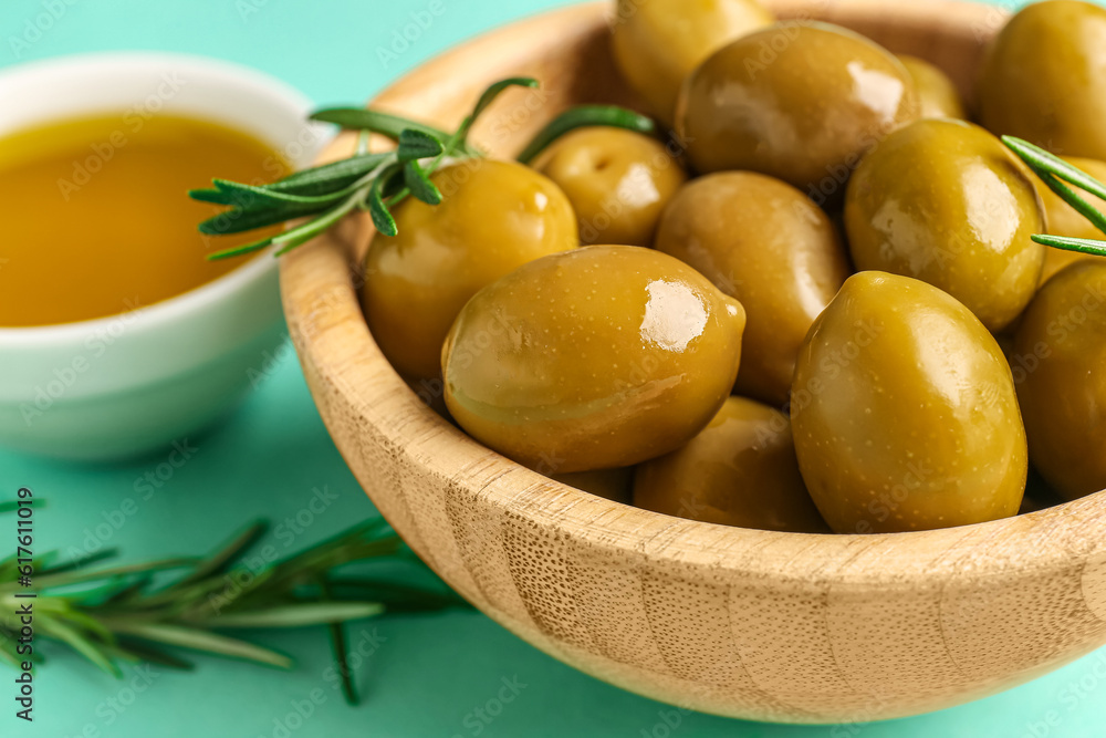 Bowl with ripe olives on turquoise background, closeup Bowl with ripe olives on turquoise background, closeup