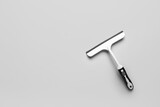 White plastic squeegee on grey background