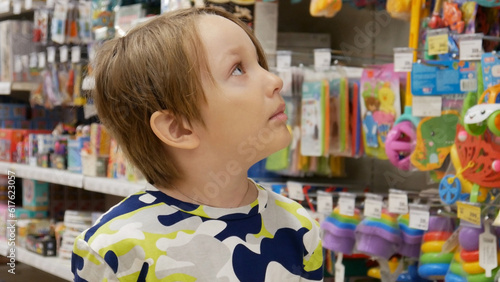 Close-up of a cute boy looking at goods in a toy store