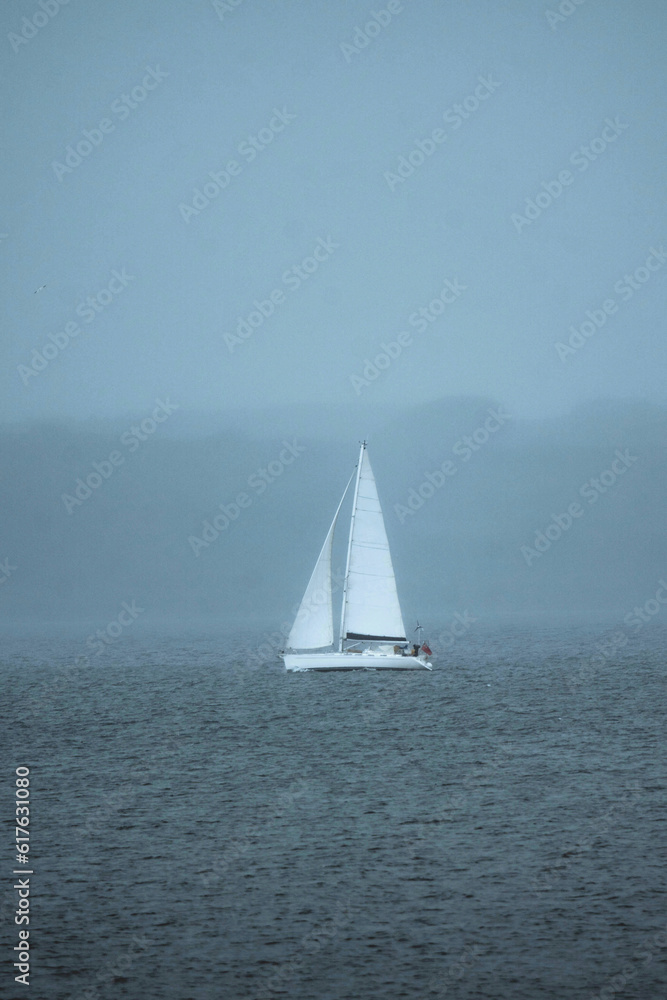 Fog taking over the sailing boat on the sea