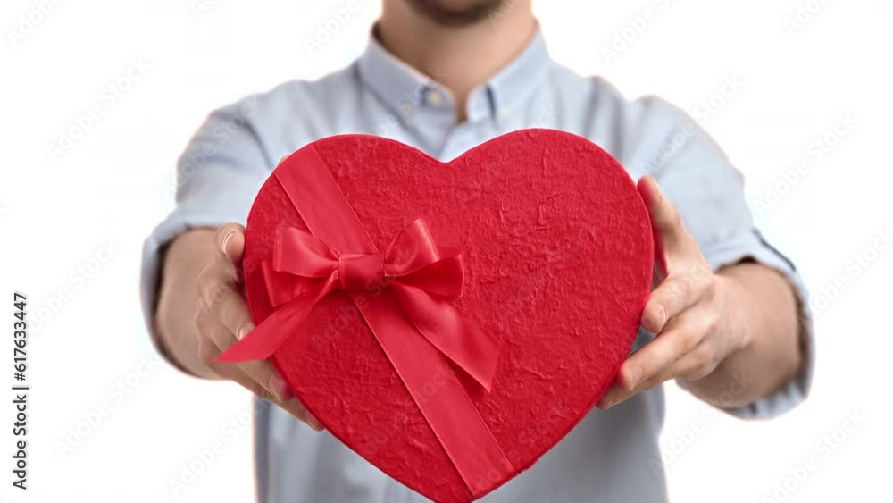 Unrecognizable man giving red heart love wrapped gift box holiday surprise posing isolated closeup Unrecognizable man giving red heart love wrapped gift box holiday surprise posing isolated closeup