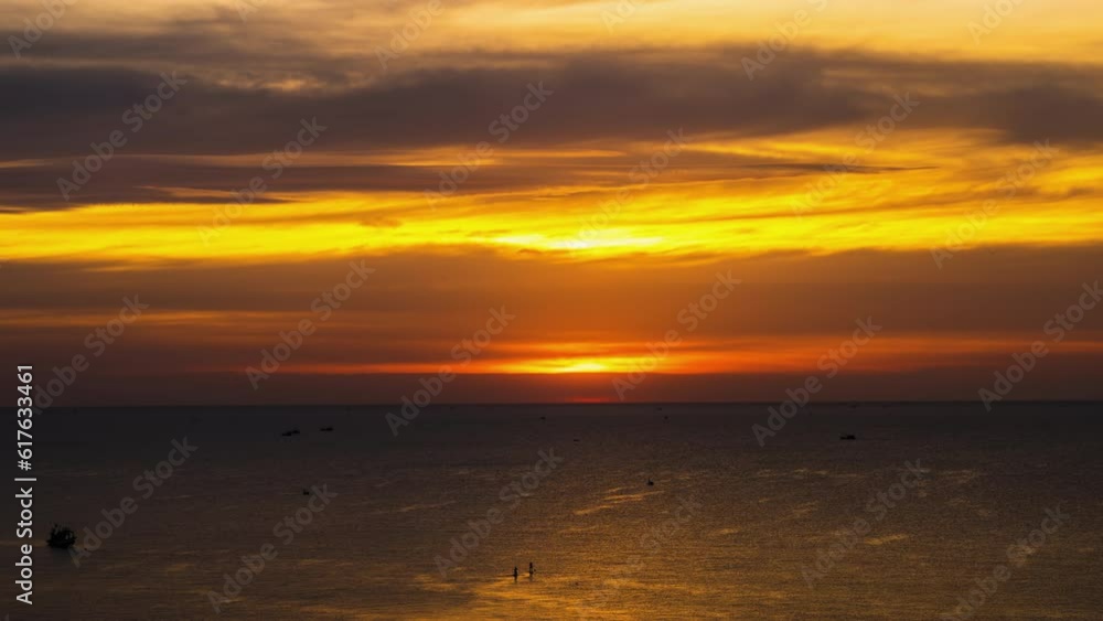 A Golden Idyllic Sunset. The Sun Sets Into The Waters of The Gentle Ocean Surface. A Golden Idyllic Sunset. The Sun Sets Into The Waters of The Gentle Ocean Surface.