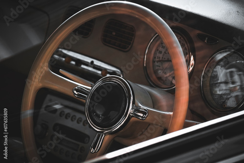 Close up of the steering wheel of a retro vehicle © Andreea_Prodan