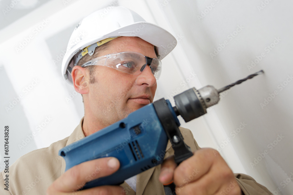 man drilling the wall with drill perforator man drilling the wall with drill perforator