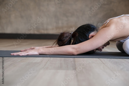 Woman practicing yoga and stretching.