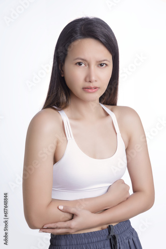 Asian woman suffering from a stomach ache on white background