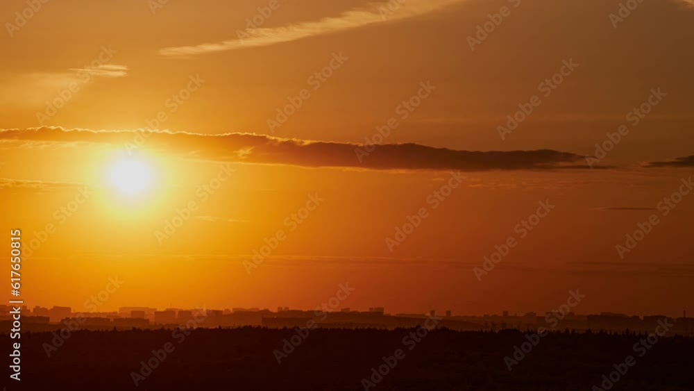 The large, fiery sun slowly descended behind the horizon during the evening's twilight, painting the sky with a warm orange glow. The large, fiery sun slowly descended behind the horizon during the evening's twilight, painting the sky with a warm orange glow.