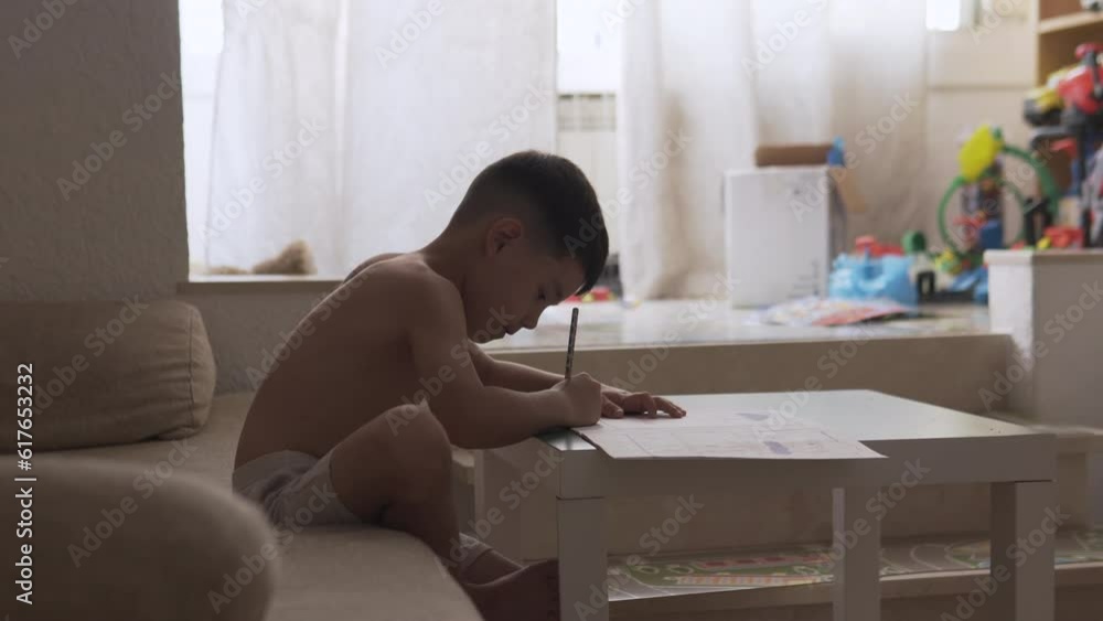 Kid doing summer homework from school at home. Curious good boy studying and asking questions about math and science. Homeschooling activities. Kid doing summer homework from school at home. Curious good boy studying and asking questions about math and science. Homeschooling activities.