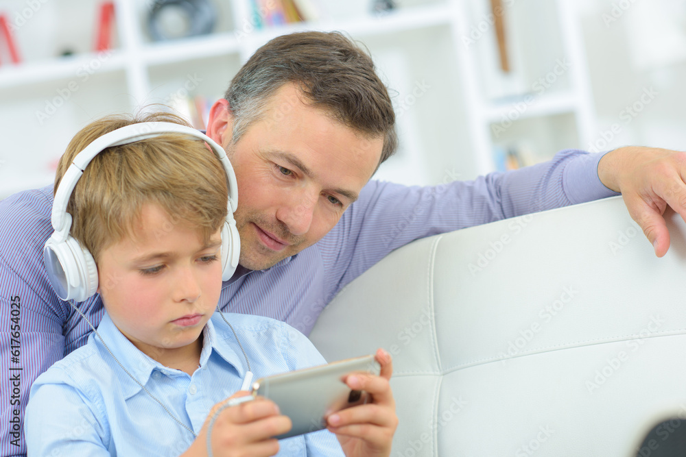 young boy busy playing on the smartphone young boy busy playing on the smartphone