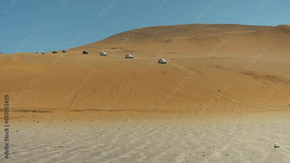 Line of trucks in caravan driving in sand dunes desert Ica Peru 1080p 120fps Line of trucks in caravan driving in sand dunes desert Ica Peru 1080p 120fps