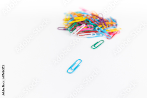 A pile of colorful paper clips. white background