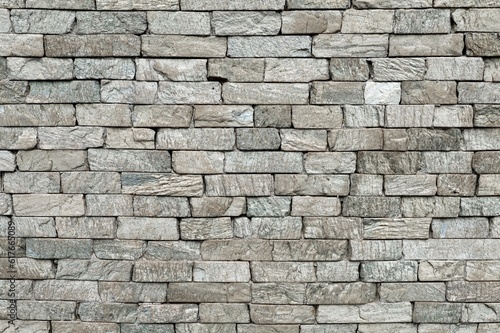 Gray stone brick wall. Background and texture, full frame.
