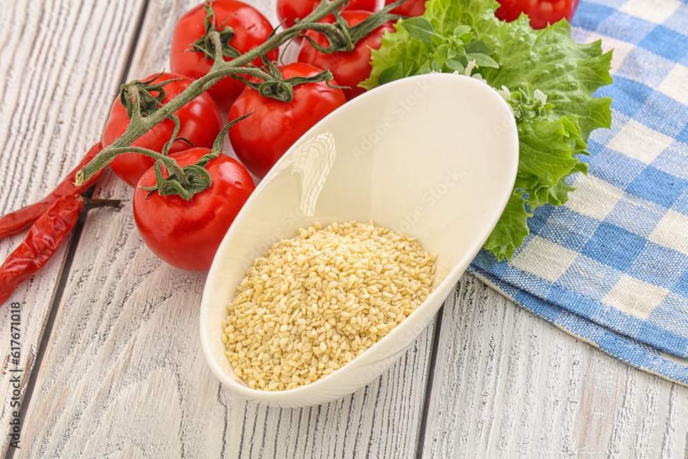 Raw sesame seeds in the bowl Raw sesame seeds in the bowl