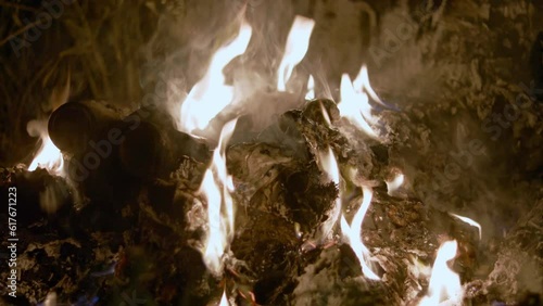 Fire burning garbage on outside at night