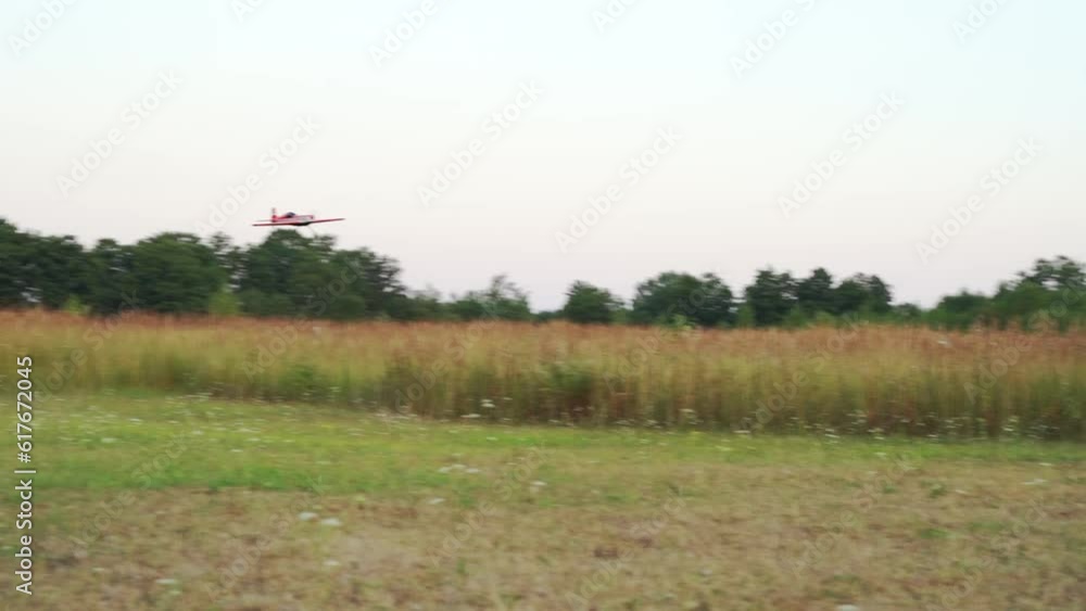 A radio-controlled model of an airplane on takeoff and flying in nature A radio-controlled model of an airplane on takeoff and flying in nature