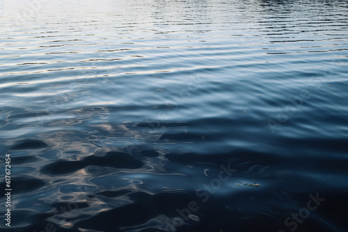 Beautiful view on the water in the daylight. At the flat surface of water gentle waves are visible created with generative AI technology