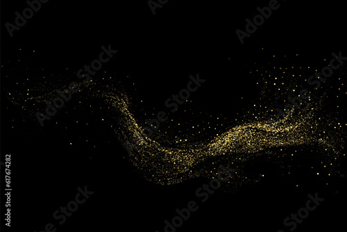 Fotografiet Scattered golden particles on a dark background