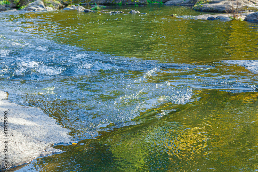 flow of water and spray from a stone flow of water and spray from a stone