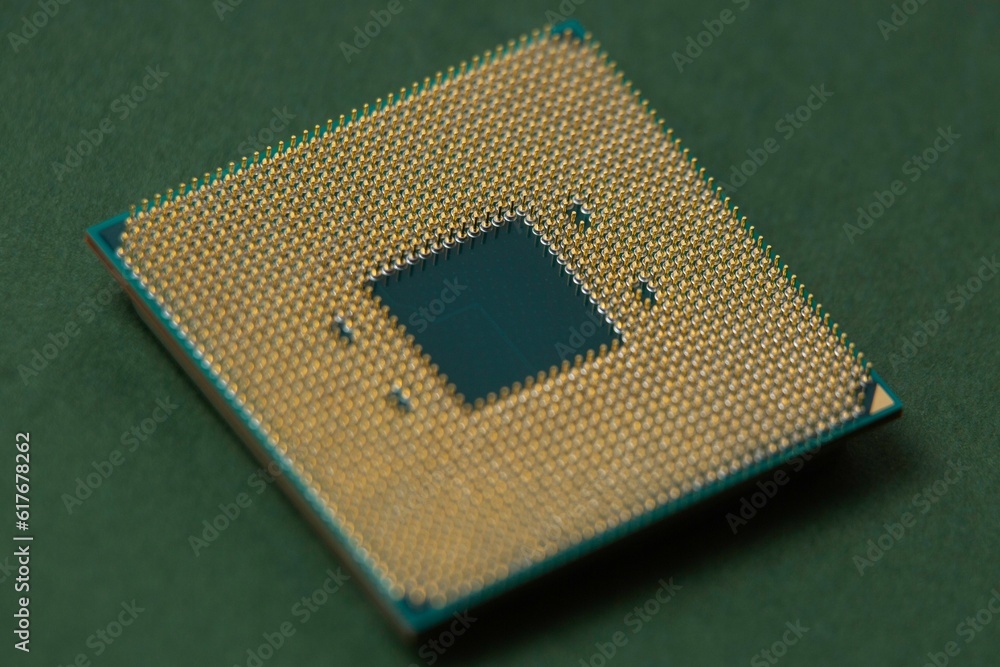 Processor for a computer lies on an isolated green background Processor for a computer lies on an isolated green background